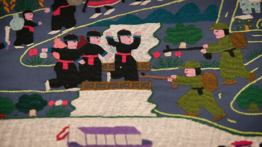 A Hmong tapestry shows refugees attempting to cross the Mekong river.