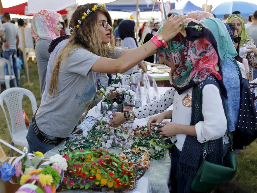 Women make flower garlands at the carnival. This year's theme is diversity, to encourage Iraqis to overcome sectarianism.