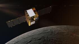 This artist's concept depicts NASA's Lunar Trailblazer in lunar orbit about 60 miles (100 kilometers) from the surface of the Moon. The spacecraft weighs only 440 pounds (200 kilograms) and measures 11.5 feet (3.5 meters) wide when its solar panels are fully deployed. Lunar Trailblazer is managed by NASA's Jet Propulsion Laboratory, and its science investigation and mission operations are led by Caltech with the mission operations center at IPAC. Managed for NASA by Caltech, JPL also provides system engineering, mission assurance, the HVM3 instrument, as well as mission design and navigation. Lockheed Martin Space provides the spacecraft, integrates the flight system, and supports operations under contract with Caltech.
