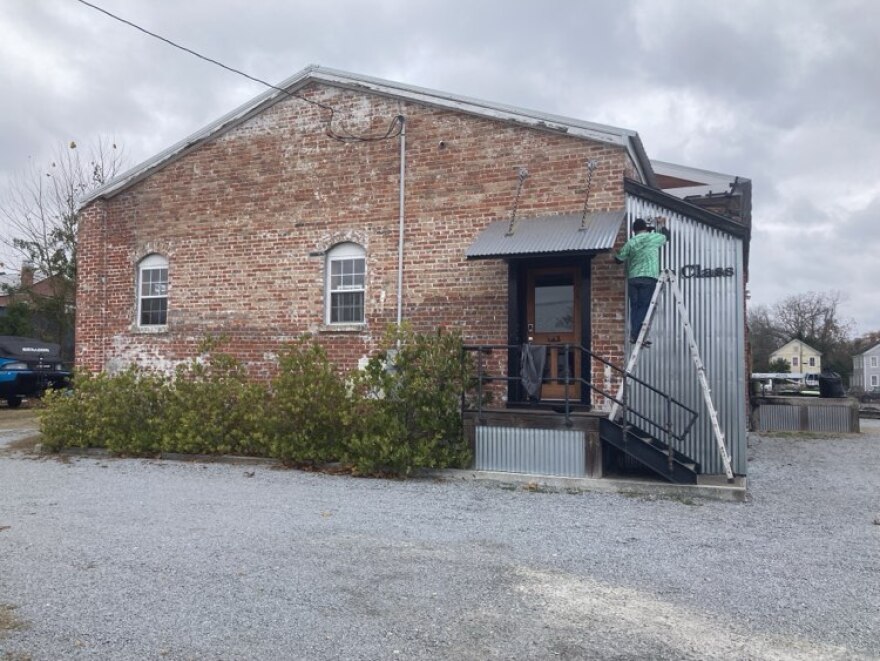 HGTV hosts might describe the recently renovated Shop Class building as a meld of history and modernism, it’s brick exterior and arched window openings offset by shiny, newer corrugated metal and surrounded by black metal fencing and an electronic gate. Owner Maurice Howland said, “It's a 100-year-old bulk petroleum warehouse and was originally Ashford Oil company.”