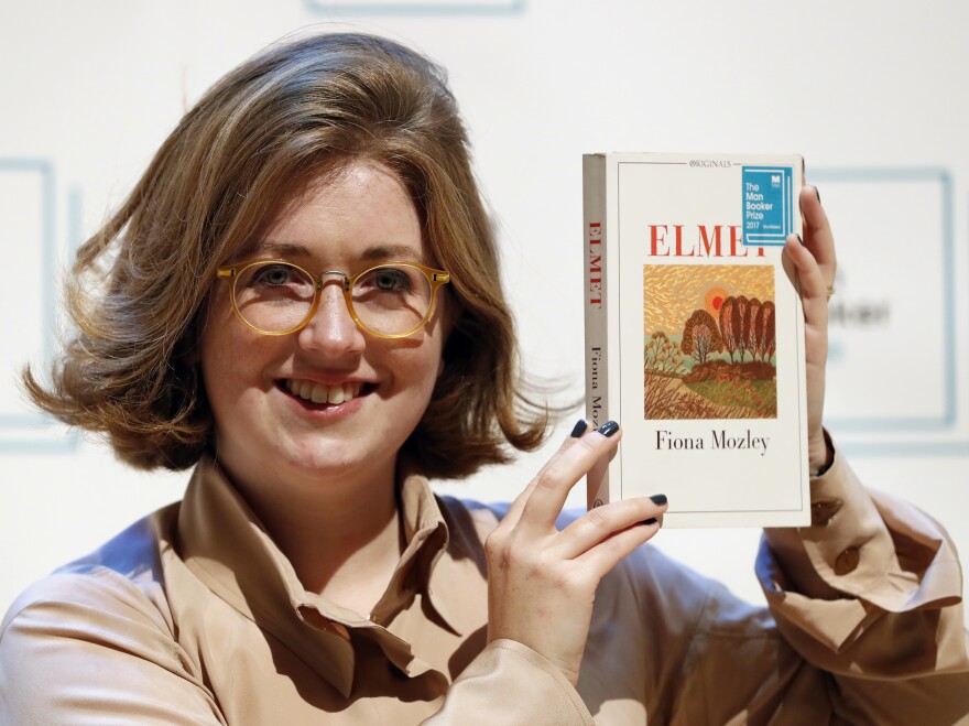 Author Fiona Mozley poses with her book <em>Elmet</em>.