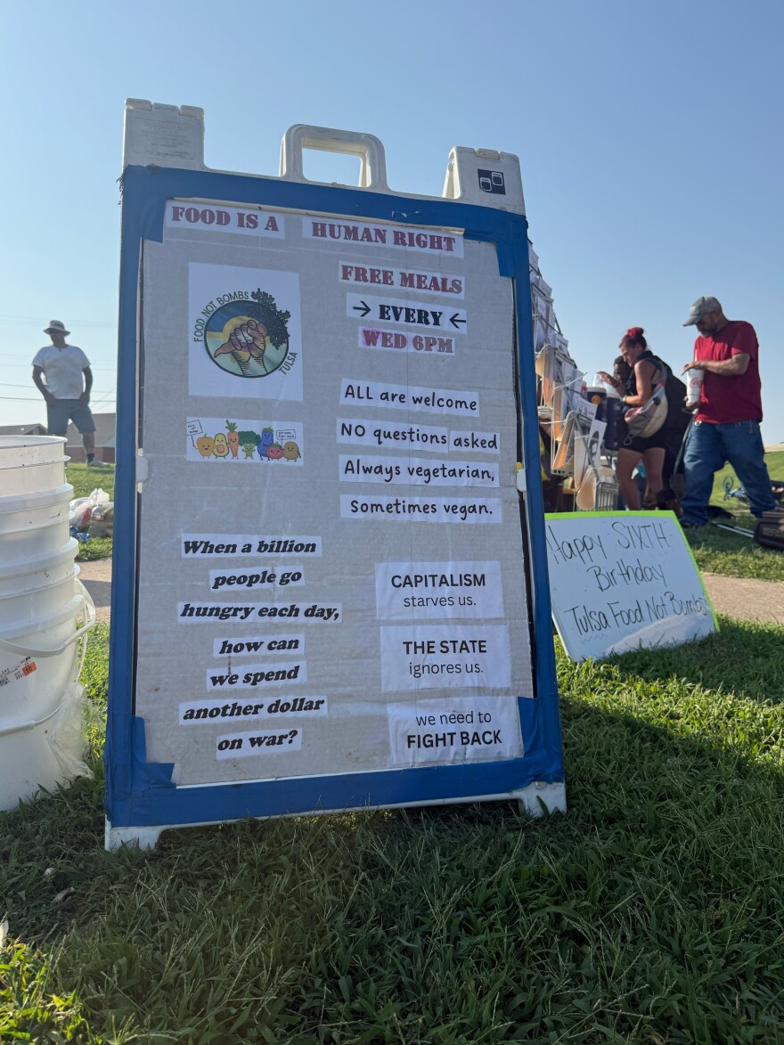 Signs displayed by Tulsa Food Not Bombs volunteers during one of their weekly "sharings."