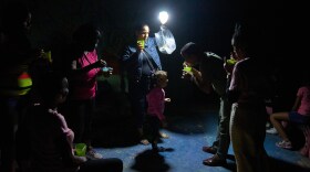 A man gives a girl a spoonful of soup on a street during a blackout in Havana, Wednesday, March 4, 2026. (AP Photo/Ramon Espinosa)