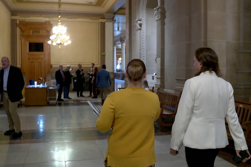 State representative Tonya Pfaff walks to meet constituents from her district at the statehouse.