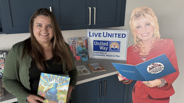 Angela Bassani, President & CEO of United Way of Lackawanna, Wayne & Pike, holds one of the first books children receive from Dolly Parton's Imagination Library. The United Way runs the local chapter of the library program.