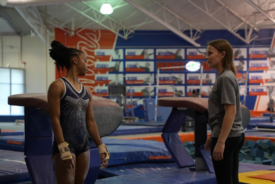 UF gymnastics student manager Peyton Harbert gives some pointers to Florida gymnast Anya Pilgrim after an attempt. “She's like all of our closest friends at this point,” Florida gymnast Danie Ferris said. (Alexis Vivanco/WUFT Sports)