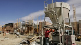 A worker mixes cement at a new shopping complex under construction in Utah. (Douglas C. Pizac/AP)