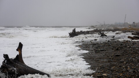 Waves, driftwood and foam cover the shore in Nome as a slow-moving Bering Sea storm pummeled the Western Alaska coast on Oct. 23, 2026.