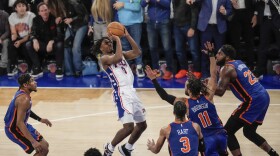 Philadelphia 76ers' Tyrese Maxey (0) shoots over New York Knicks' Jalen Brunson (11), Mitchell Robinson (23) and Josh Hart (3) during the second half of Game 5 in an NBA basketball first-round playoff series, Tuesday, April 30, 2024, in New York. The 76ers won 112-106 in overtime. (AP Photo/Frank Franklin II)