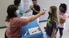 Science teachers Ann Darby, left, and Rosa Herrera check in students before a summer STEM camp at Wylie High School on July 14.