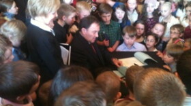 Utah Governor Gary Herbert signs HCR2, surrounded by 4th graders who lobbied to correct an error in Utah's state flag.