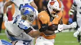 Tampa Bay Buccaneers running back Rachaad White is brought down by Detroit Lions linebacker Alex Anzalone 