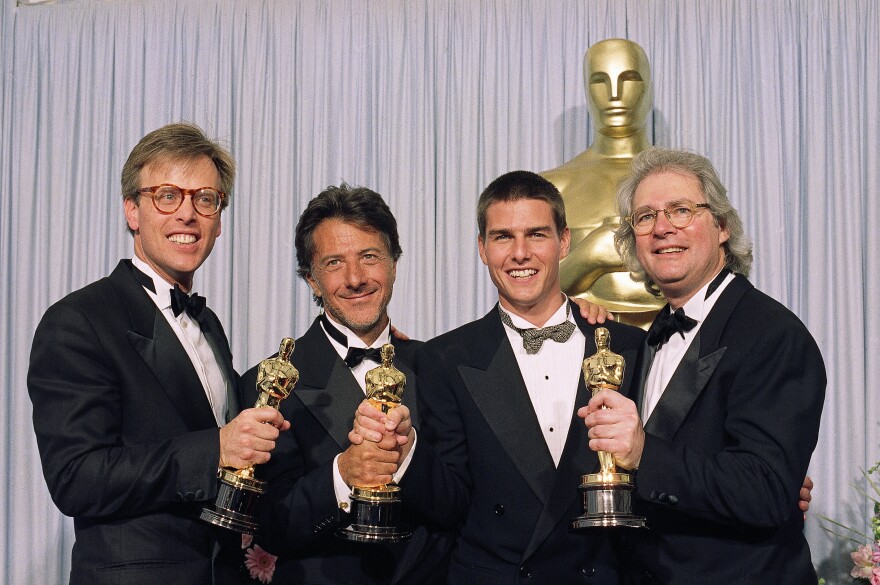 The principals of 1989's best film, from left, Mark Johnson, Dustin Hoffman, Tom Cruise and Barry Levinson are all smiles as they display their Oscars at the 61st Annual Academy Awards in Los Angeles, March 29, 1989 after 'Rain Man' was named best film.