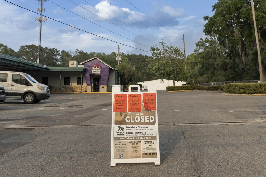 A sign outside the Humane Society of North Central Florida announced that all of its animals had been placed in foster homes as smoke from a nearby wildfire lingered over Gainesville on April 19. The shelter evacuated 40 dogs and 18 cats that day.
