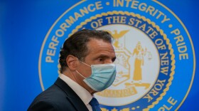 Gov. Andrew Cuomo enters his daily coronavirus briefing in New Rochelle on Friday.