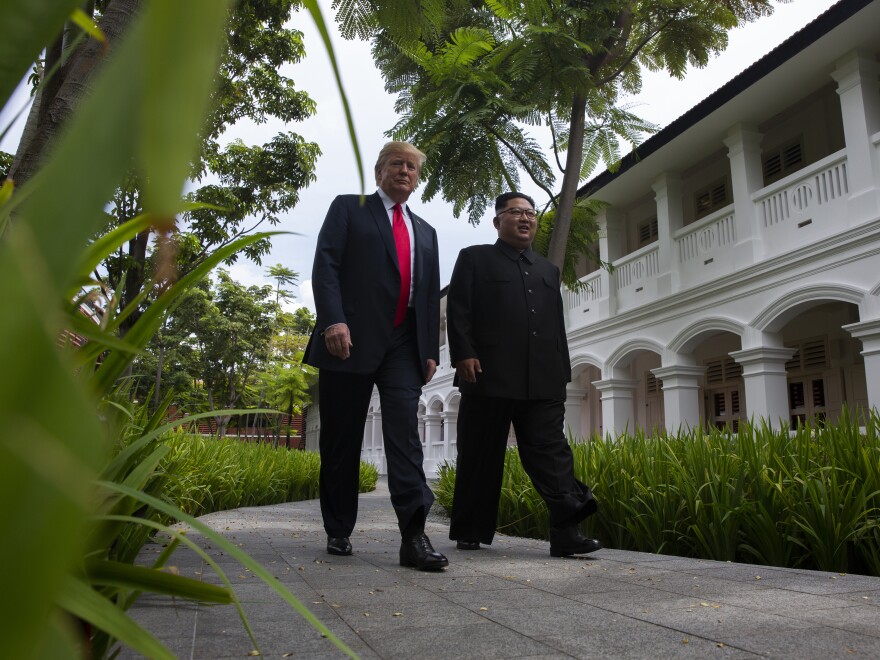 President Trump walks with North Korean leader Kim Jong Un on Tuesday on Sentosa Island in Singapore.