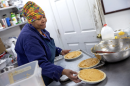 Pastry chef Carla Jones loads a trio of sweet potato pies onto a tray destined for the oven on Nov. 15 at Ol’ Henry’s Restaurant in Berkeley, Missouri. Sweet potato pie is a significant touchstone of African American culture, especially around Thanksgiving.