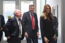 Local and federal officials enter a university building.