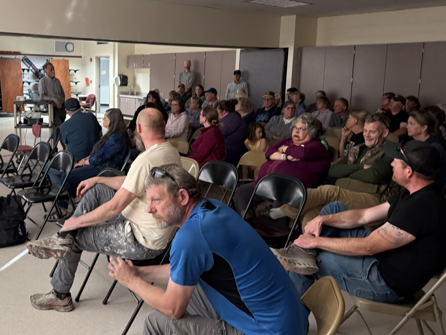 People listen to Kenai Peninsula Borough Mayor Peter Micciche talk during a meeting at Tustumena Elementary School on Monday, June 15, 2026 in Kasilof, Alaska.