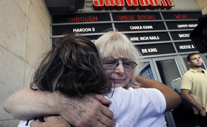 Longtime employees hug as they leave the Showboat Casino Hotel on Aug. 31, the day it closed.