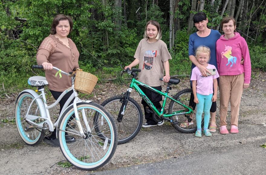 From left, Tatiyana Haidai and her daughter,  Alina, show off their new bikes. At right are Anna Storozhuk and her daughters Rima and Diana.