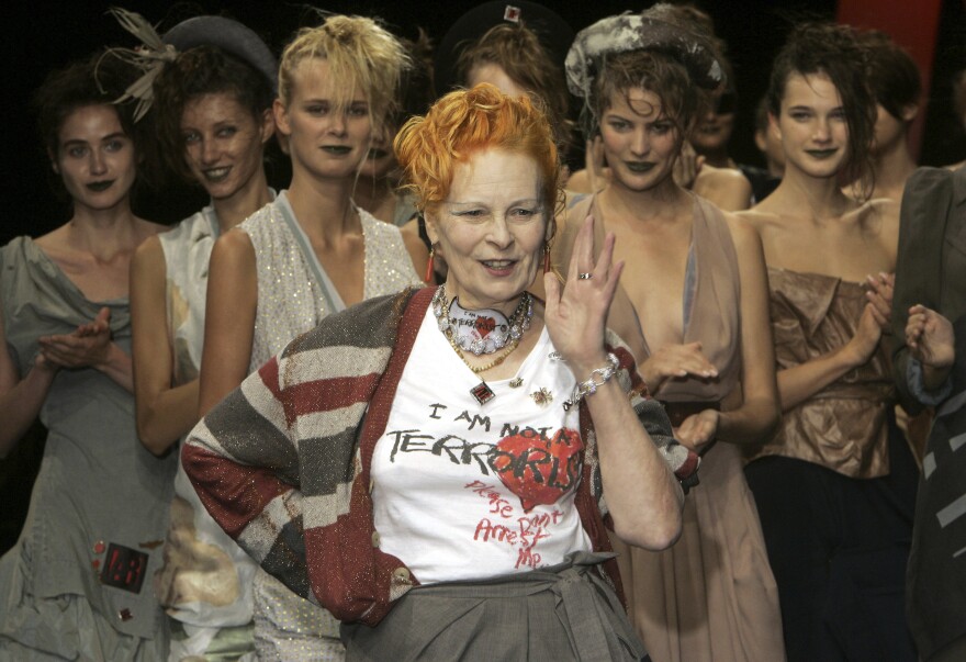 Models applaud as British fashion designer Vivienne Westwood salutes the public after the presentation of her Spring/Summer 2006 collection in Paris, Tuesday, Oct. 4, 2005.