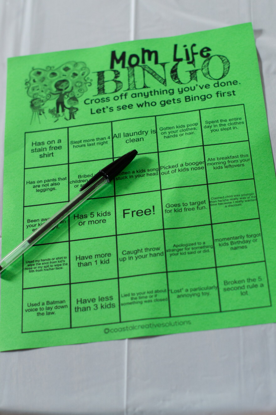 "Mom Life Bingo" sheets for the adults and coloring pages for the kids were spread out on tables.