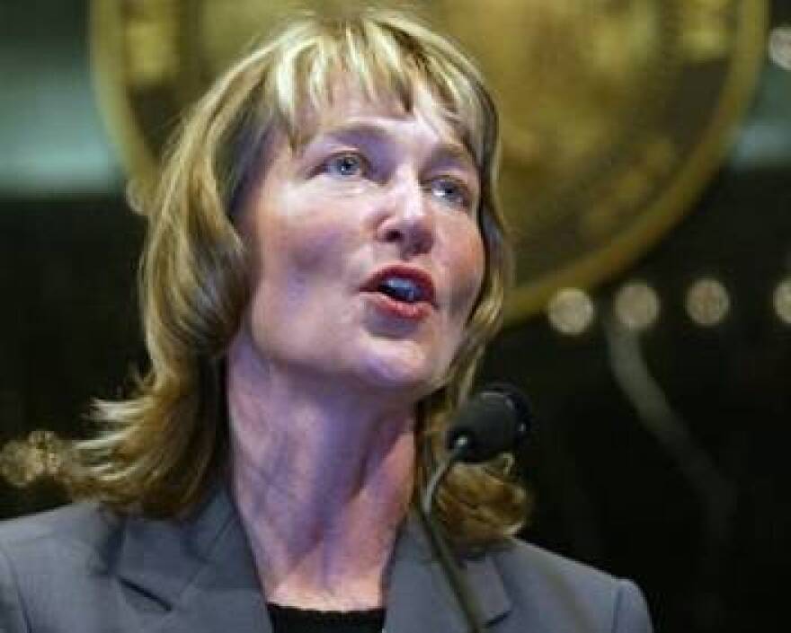 In this Oct. 20, 2003 file photo, Kathy Davis addresses the Indiana House after her nomination as Indiana's lieutenant governor was approved in an unanimous voice vote by the House at the Statehouse in Indianapolis. U.S. Sen. Joe Donnelly lost his campaign treasurer Wednesday, Aug. 5, 2015 after he was one of two Democrats to vote with Republicans in an unsuccessful effort to strip Planned Parenthood of federal funding.