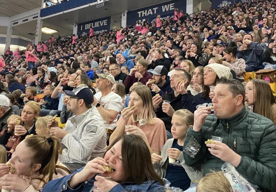 Audience members at the Dee Glen Smith Spectrum dunk and eat cookies in attempt to break a Guinness World Record on Friday.