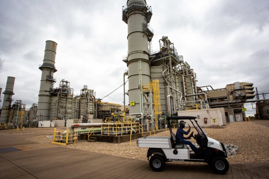 A person drives past the power plant.
