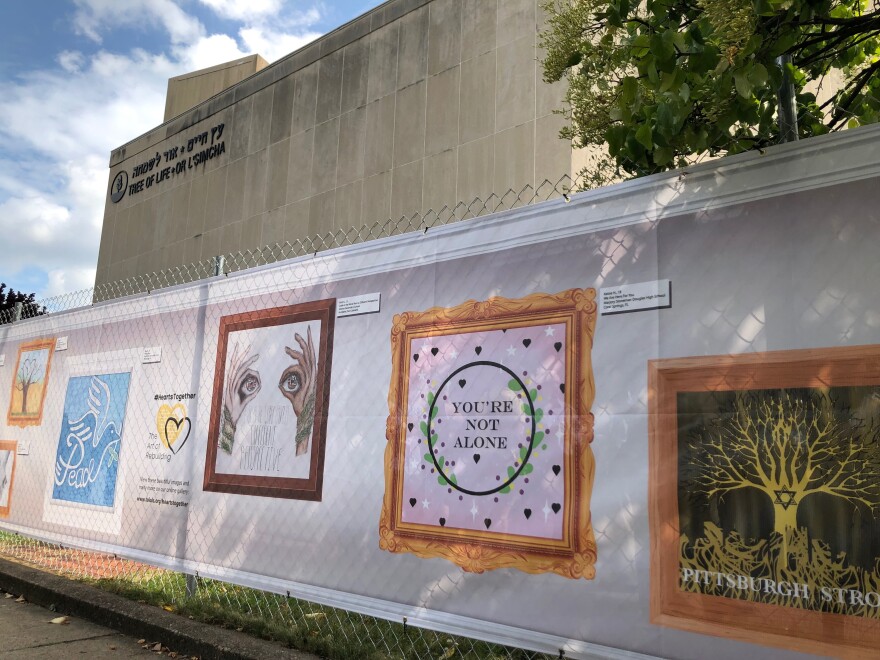 The fence in front of the Tree of Life synagogue has been decorated with 101 images from young people around the country and in New Zealand. It has been installed nearly one year after a mass shooting took place in the building. [Kathleen J. Davis / 90.5 WESA]