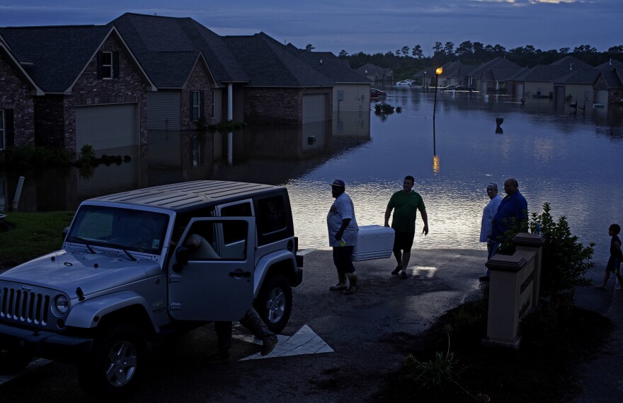 Residents evacuate with food in ice chests in Hammond, La., on Saturday.