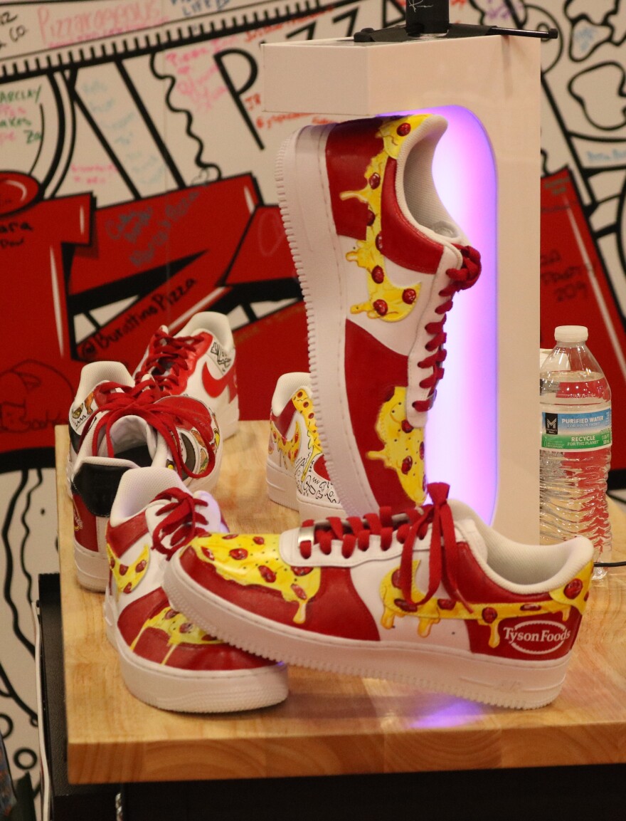 A set of sneakers with pizza-colored designs on them. 