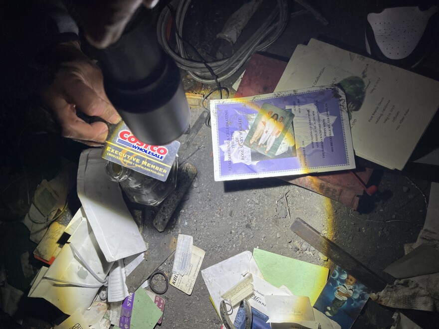 Close-up of Costco card and personal items in trash pile