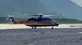 a helicopter in front of mountains