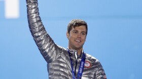 Men's snowboard cross bronze medalist Alex Deibold of the United States smiles during the medals ceremony at the 2014 Winter Olympics, Tuesday, Feb. 18, 2014, in Sochi, Russia.