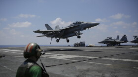 A fighter jet lands on the USS George H.W. Bush aircraft carrier on Thursday, June 22, 2017 in the Mediterranean Sea. F18 fighter jets launch multiple times a day from the carrier bombing the Islamic State positions in Iraq and Syria. (Bram Janssen/AP)