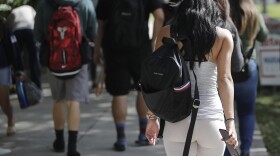 FILE- In this Oct. 23, 2018, file photo, students walk on the campus of Miami Dade College
