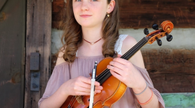 Image of young female musician holding fiddle