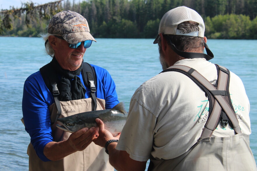 Monte Roberts (right) helps Scott Bardreau (left) pose with his first Alaska salmon during a guided fishing trip on Tuesday, Aug. 11, 2026 in Soldotna, Alaska.