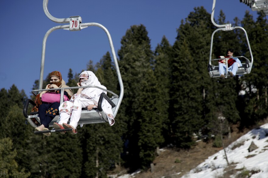 Women ride the chairlift at a new ski resort.