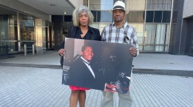 Gladys and Herman Whitfield Jr. hold a photo of their son Herman.