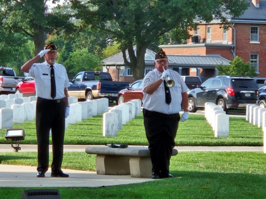 A bugler plays Taps at Camp Butler National Cemetery.