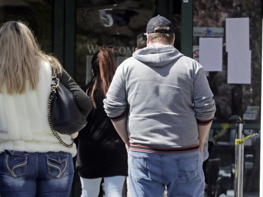 People line up outside the Utah Department of Workforce Services in Salt Lake City. [Rick Bowmer / AP]