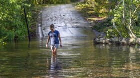 Teresa Elder walks through flood waters in Morganton, NC.