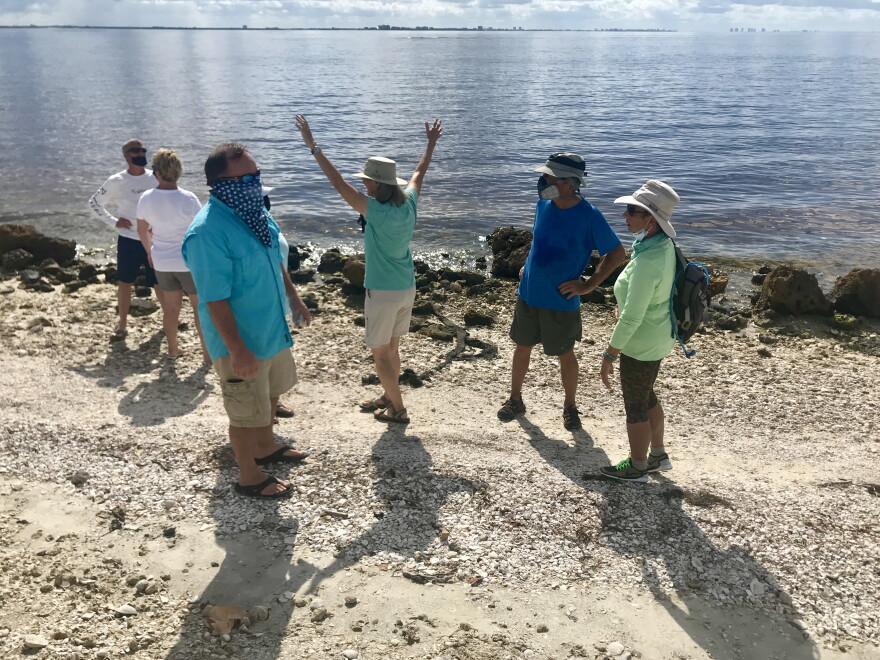Some at the Sanibel "Hands Along the Water" demonstration wear breathing masks to guard against the effects of red tide.