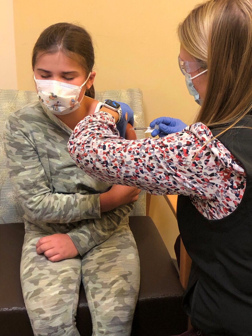 Charlotte Grantham, a 10-year-old who attends Falmouth Elementary School, gets a shot of coronavirus vaccine.