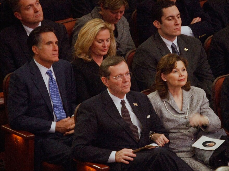 Mitt and Ann Romney sit behind Michael Leavitt and his wife Jacqueline at the February 2008 funeral of Gordon B. Hinckley, leader of the Church of Jesus Christ of Latter-day Saints. Romney reportedly has chosen Leavitt to lead his transition team.
