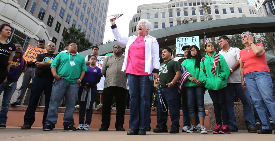 Sister Ann Kendrick (center) of the HOPE Community Center in Apopka, Fla., rallies with Hispanic immigration policy demonstrators from various groups in front of Orlando City Hall in 2012.