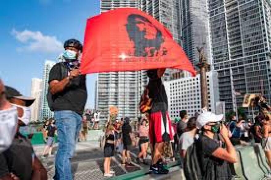 Racial justice protesters in Miami unfurl a Che Guevara banner this year.